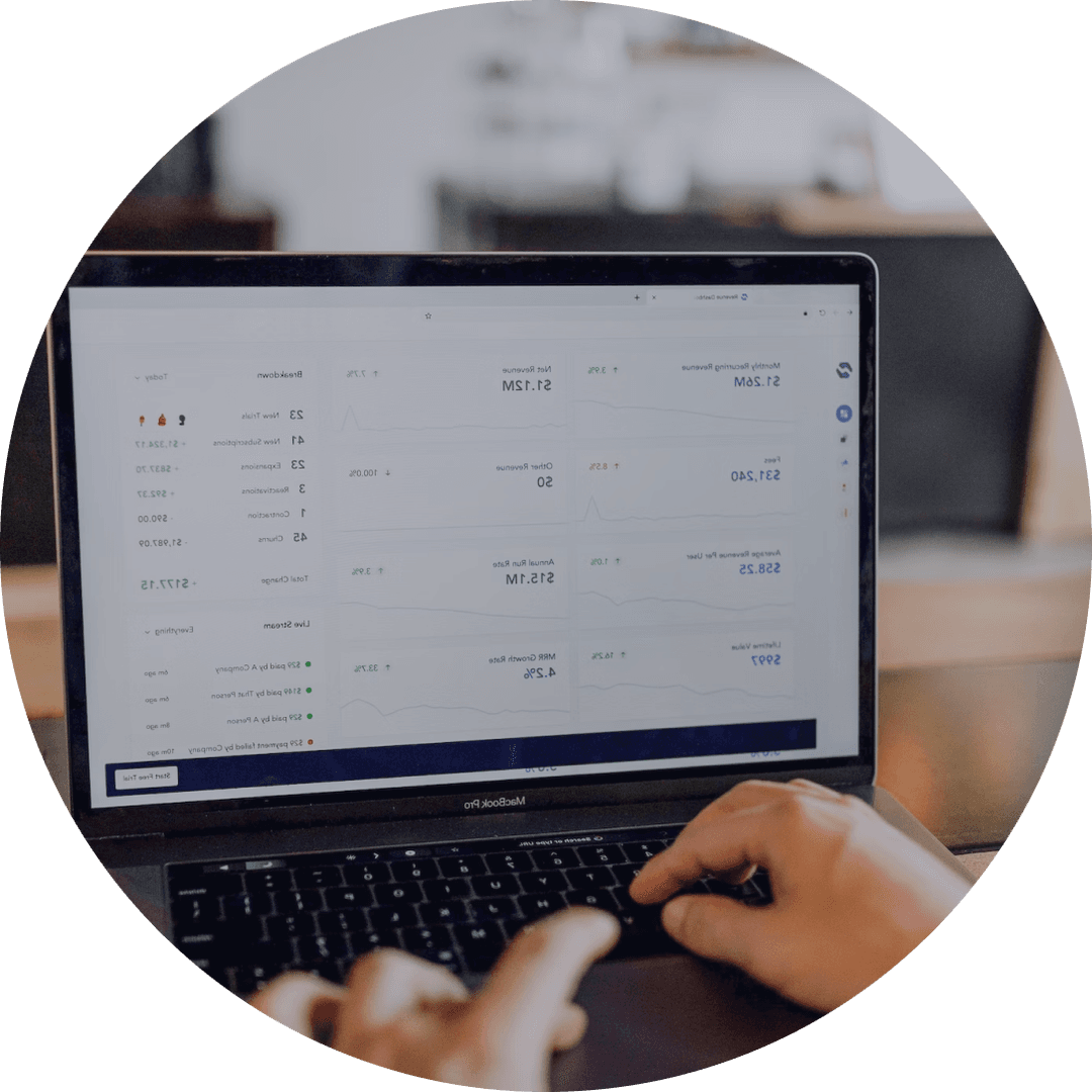 Person typing on laptop with financial data